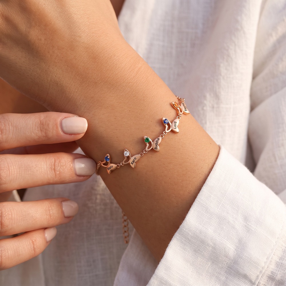 Butterfly bracelet with an engraved name and birthstone accent in gold tone