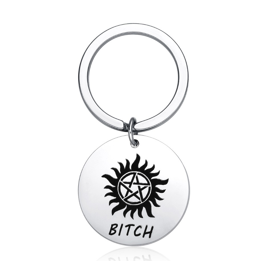 Round stainless steel keychain charm engraved with a name and set with a birthstone