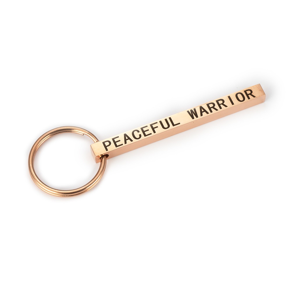 Polished stainless steel bar keychain engraved with a name and set with a single birthstone
