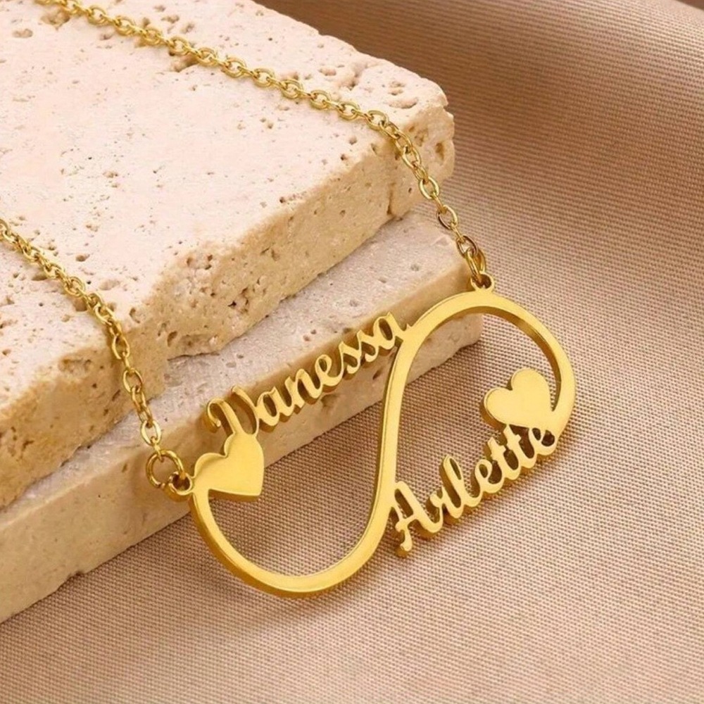 Open heart infinity pendant necklace with single-line engraving and tiny birthstone accent on a stainless steel O-link chain
