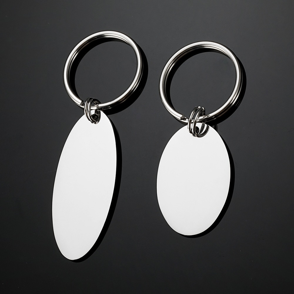 Polished oval stainless steel keychain engraved with a name and a single birthstone