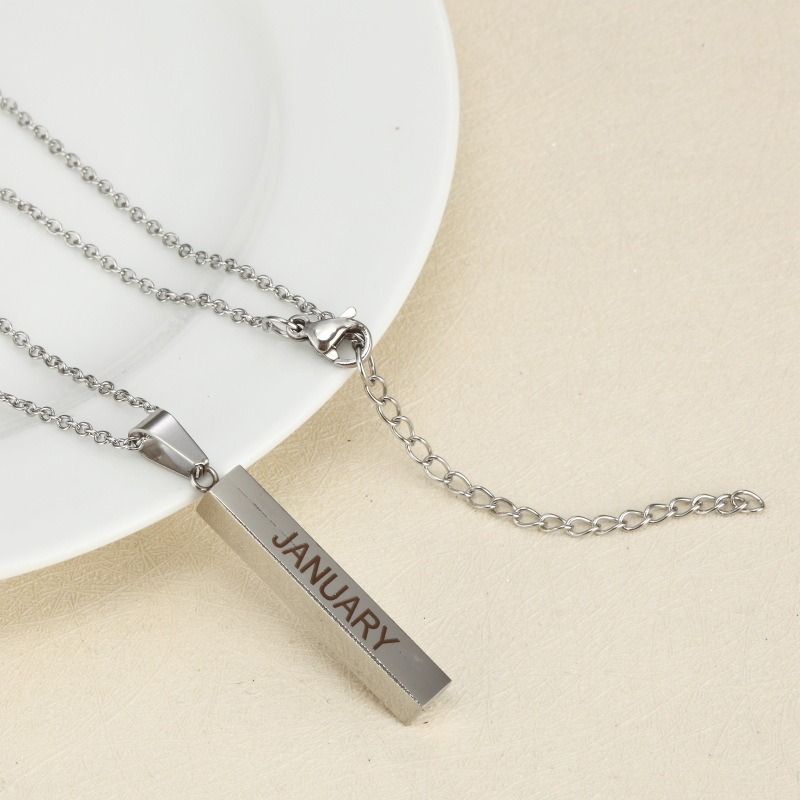 Vertical stainless steel bar necklace with custom single line engraving and optional birthstone, shown in gold tone