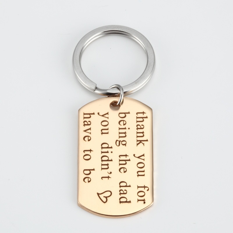 Engraved stainless steel dog tag keychain with a single birthstone accent
