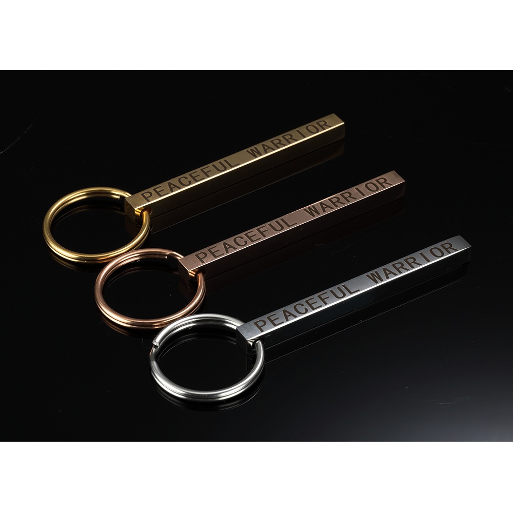 Polished stainless steel bar keychain engraved with a name and set with a single birthstone
