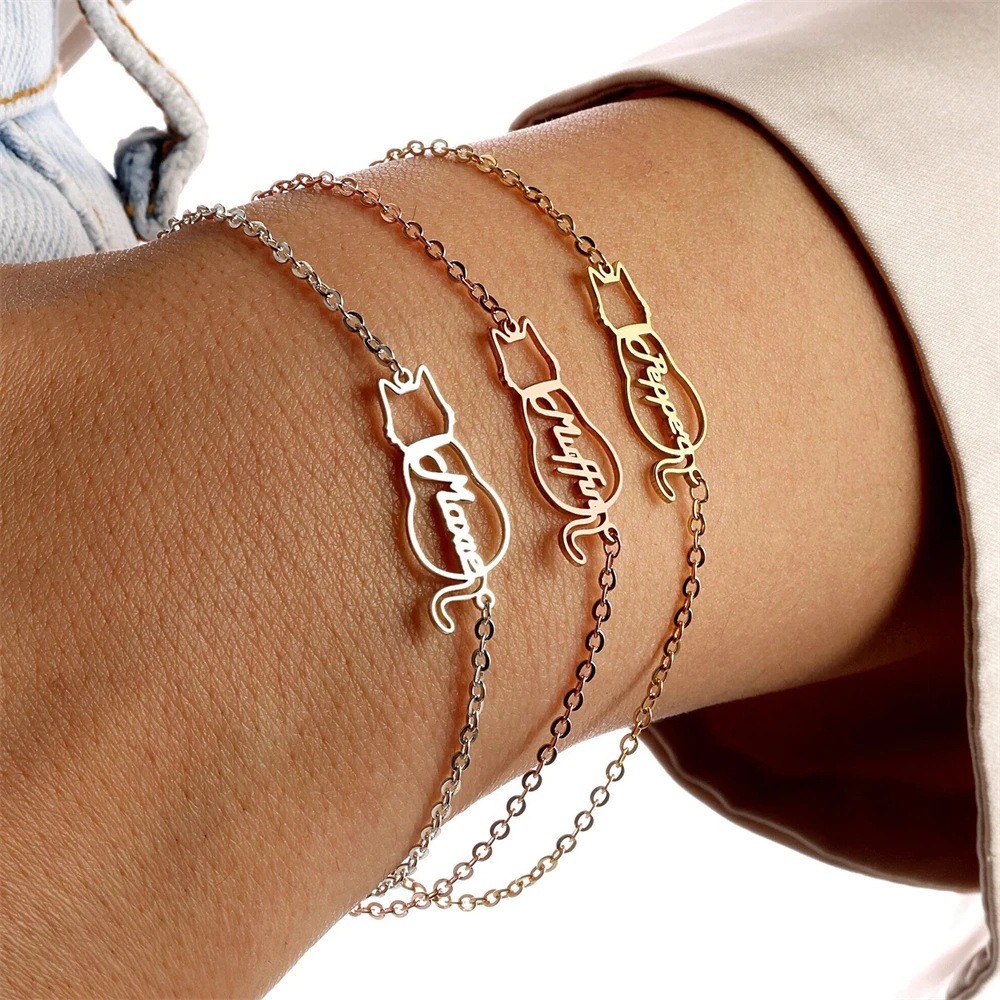 Engraved stainless steel pet name necklace with a small birthstone accent