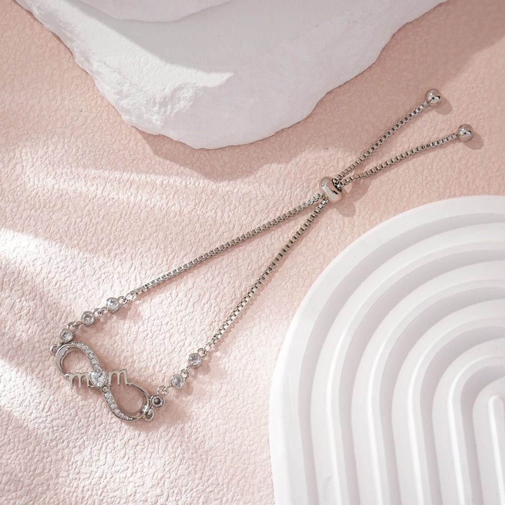 Stainless steel MOM infinity bracelet with single-line engraving and a birthstone accent