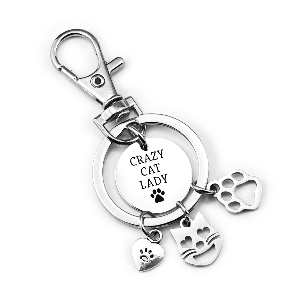 Stainless steel cat paw keychain with an engraved name and birthstone charm