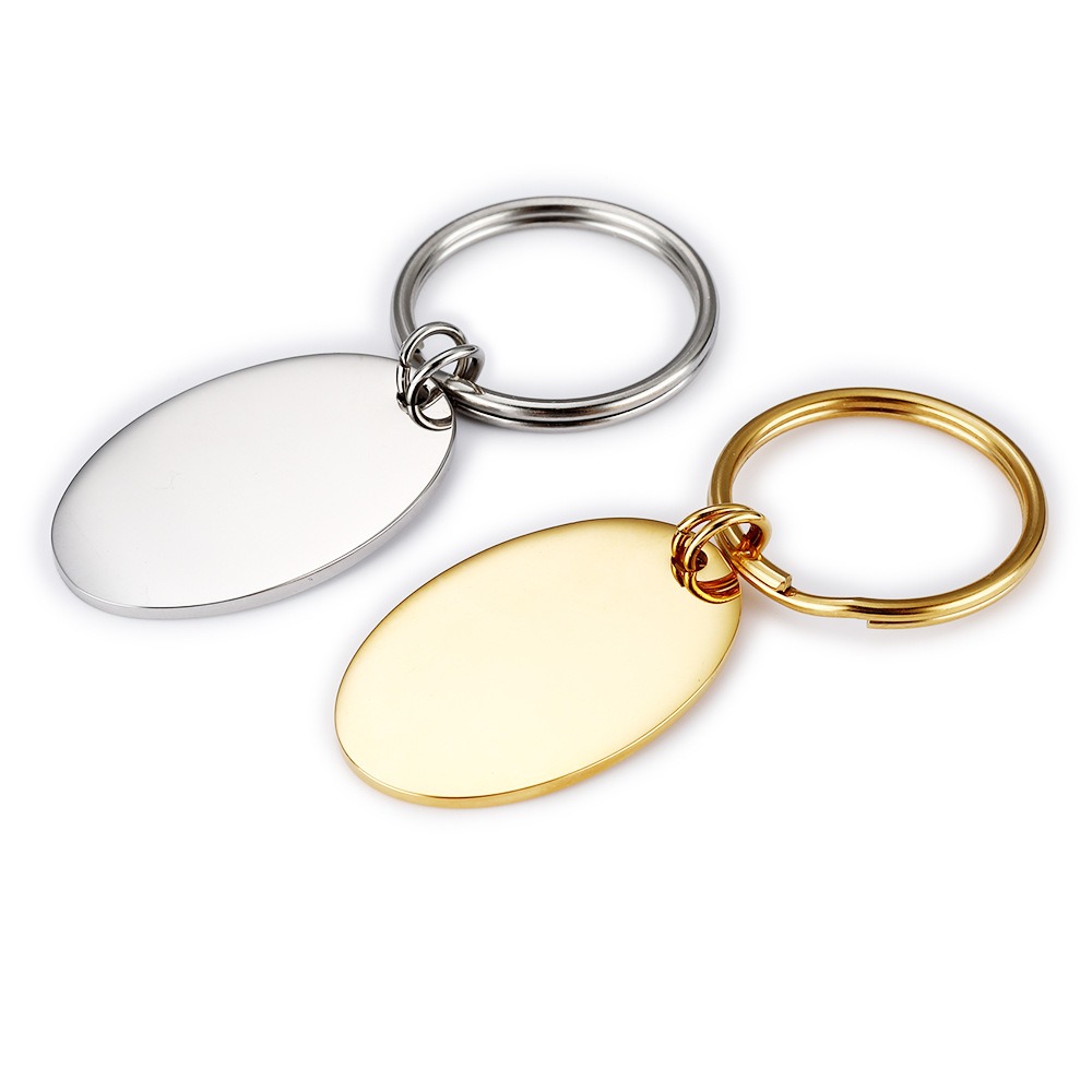 Polished oval stainless steel keychain engraved with a name and a single birthstone