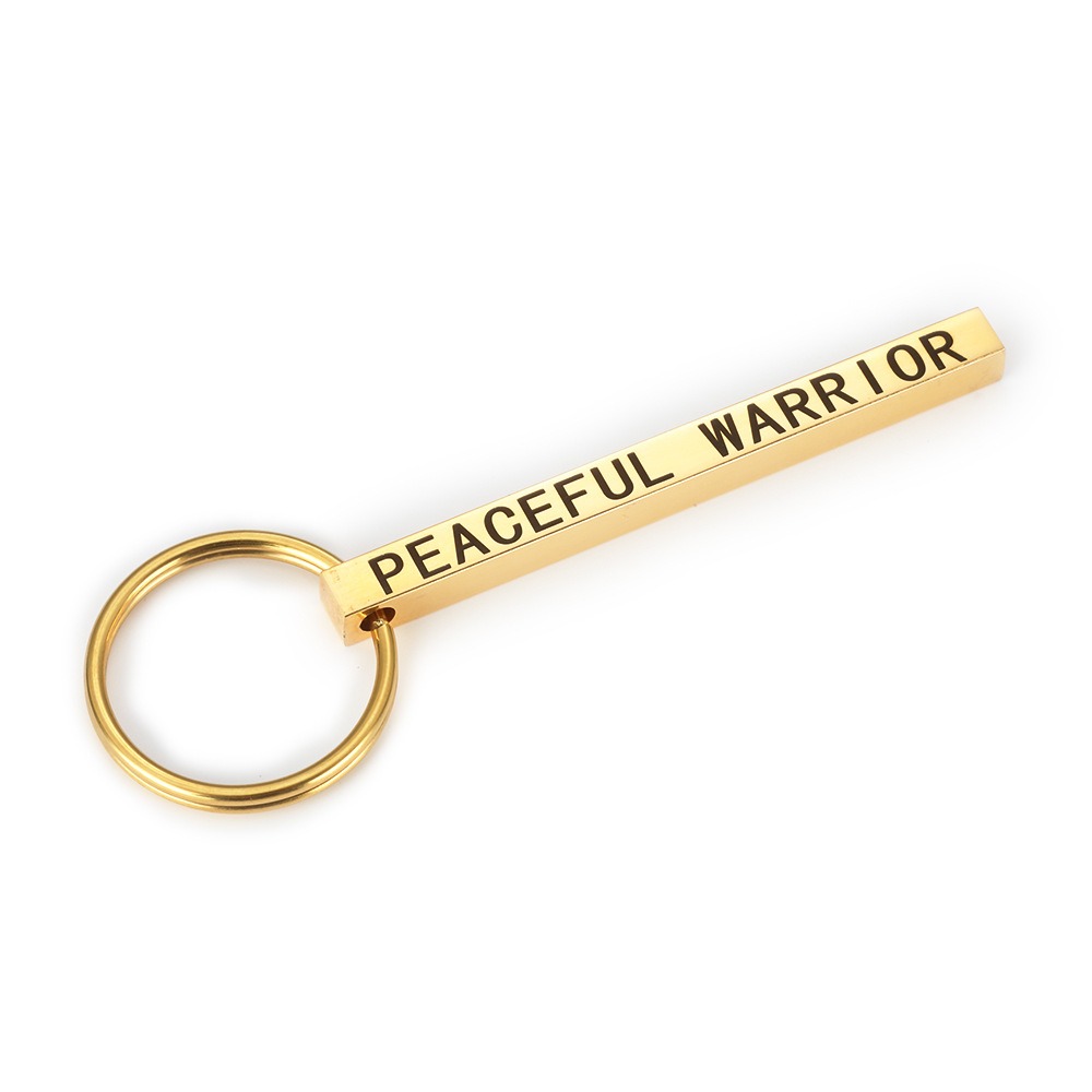 Polished stainless steel bar keychain engraved with a name and set with a single birthstone