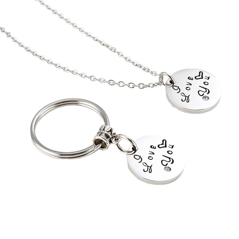 Stainless steel couple set with two engraved heart pendants, birthstones and a coil keychain