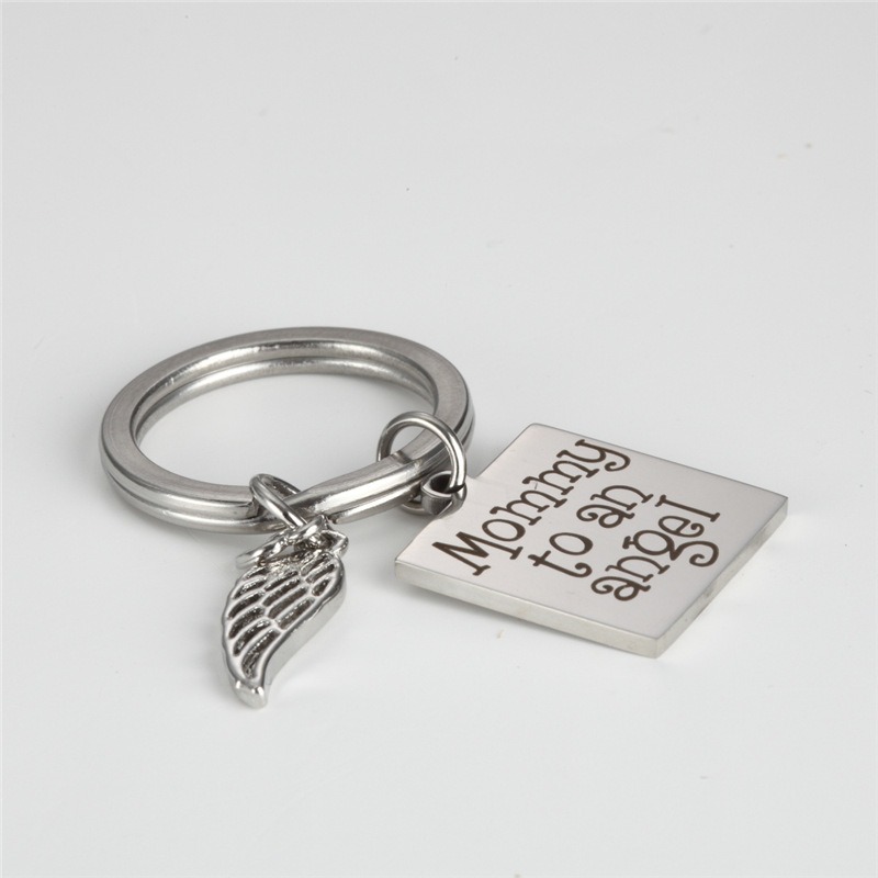 Stainless steel angel wing keychain engraved with a name and a small birthstone