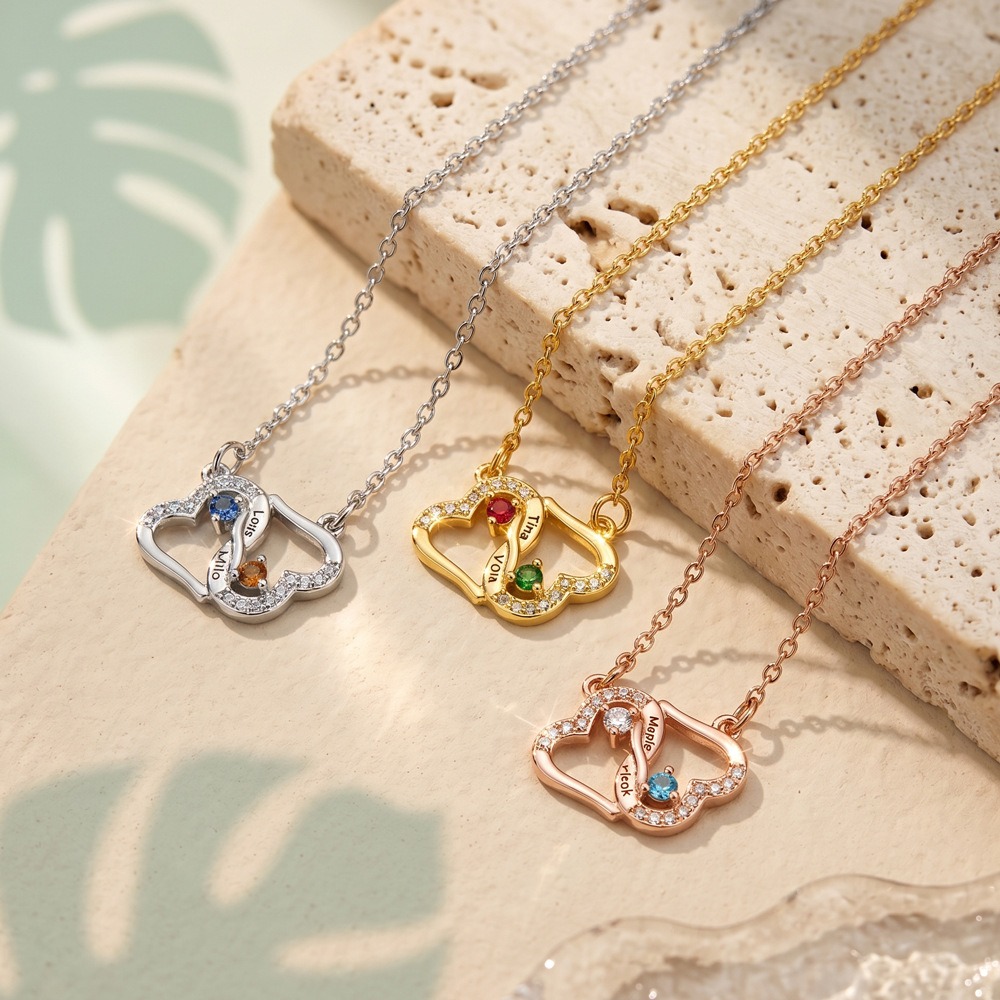Two interlocking heart name necklace with a birthstone accent on a cross chain