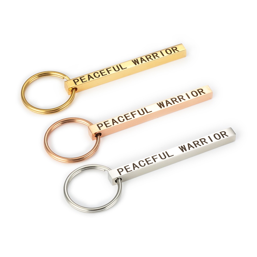 Polished stainless steel bar keychain engraved with a name and set with a single birthstone