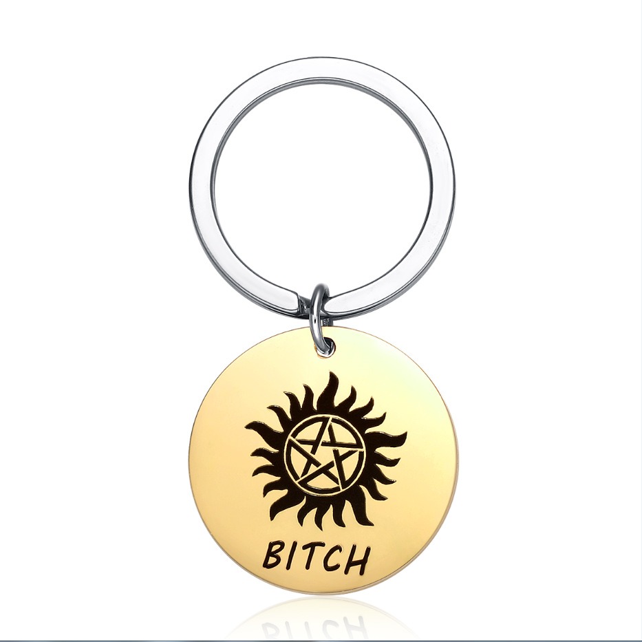 Round stainless steel keychain charm engraved with a name and set with a birthstone